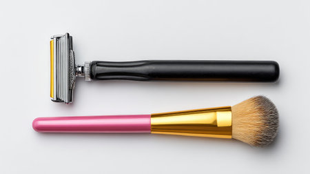 A clean and minimalist composition featuring a razor and a makeup brush, illustrating essential tools for personal grooming and makeup application on a neutral backdrop.の素材
