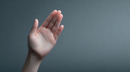 This image depicts an open human hand in a neutral tone, symbolizing communication and connection, set against a soft gradient background for a modern and elegant aesthetic.の素材