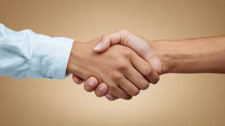 A close-up image showcasing a handshake between two individuals, capturing a moment of agreement and trust. Ideal for themes of business, collaboration, and personal connections.の素材