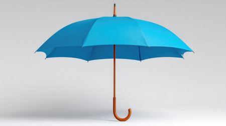 A vivid blue umbrella featuring a stylish wooden handle, perfect for visually representing rainy days and outdoor activities in various contexts and themes.の素材