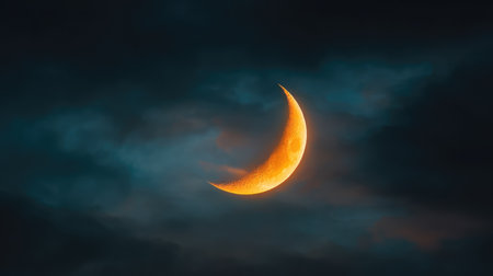 A captivating crescent moon shines brightly in a dark night sky filled with textured clouds, offering a tranquil and enchanting backdrop for various creative projects.の素材