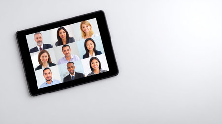 A modern tablet displays a diverse group of professionals in a collaborative setting, emphasizing teamwork and effective communication in a contemporary workspace dynamic.の素材