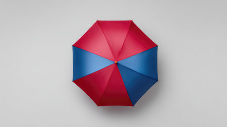 This striking umbrella features bold red and blue colors against a neutral backdrop, ideal for capturing the essence of weather protection and playful designs.の素材