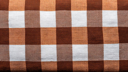 A beautiful checkered fabric featuring a mix of brown and white tones, perfect for enhancing home decor or crafting projects, adding a rustic touch to any setting.の素材