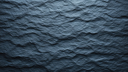 A close-up view of a dark slate surface featuring unique wavy patterns and textures, perfect for use in backgrounds or artistic projects, enhancing visual depth and interest.の素材