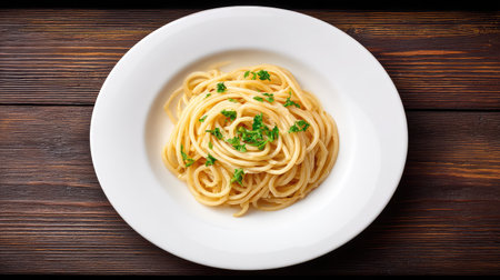 A beautifully presented plate of spaghetti garnished with fresh parsley and drizzled with olive oil, perfect for culinary showcases and Italian cuisine.の素材