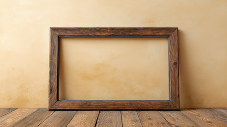 A rustic vintage frame leaning against a pastel-colored wall on a wooden floor, copy space includedの素材