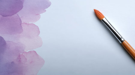 This mesmerizing image features a watercolor brush next to soft purple splashes on a clean canvas, perfect for artists seeking design inspiration and creative projects.の素材