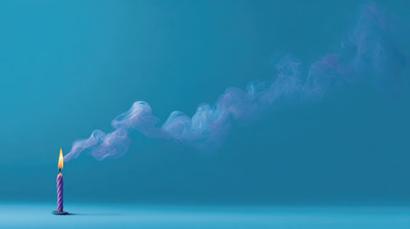 A vibrant candle with a glowing flame emits colorful wisps of smoke against a soft blue background, creating a serene atmosphere perfect for festive celebrations or artistic inspiration.の素材