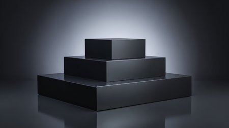 A stylish composition featuring geometric black boxes arranged on a reflective surface, illuminated by soft ambient lighting, ideal for artistic presentations or product showcases.の素材