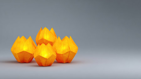 A collection of four glowing origami lanterns in vibrant orange, creating a warm and inviting ambiance ideal for enhancing home decor or special events.の素材