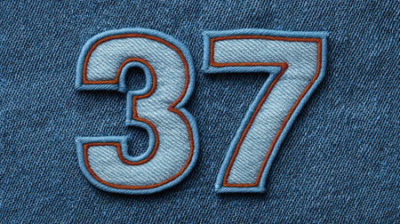 Number  stitched on denim fabric background, textile style with ample negative spaceの素材