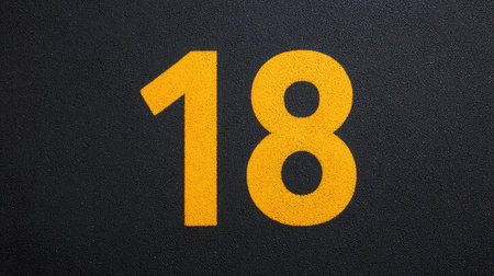 Number  painted in bold on asphalt ground, top view with ample empty areaの素材