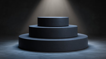 A modern black display stand featuring three tiers, illuminated by a spotlight, ideal for showcasing products or creating stunning visual effects in photography.の素材