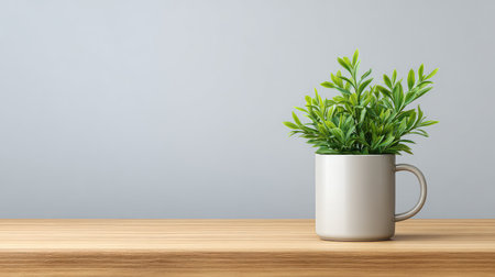 A minimalist indoor plant arrangement featuring a vibrant green plant in a simple white pot on a light wooden table, perfect for modern home or office decor.の素材