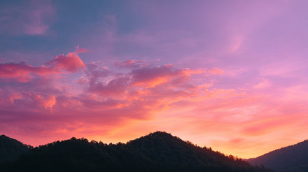 A breathtaking view of a colorful sunset over majestic mountains creates a serene atmosphere, perfect for nature lovers and landscape enthusiasts.の素材