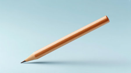 A wooden pencil stands upright against a soft blue background, capturing the essence of creativity and simplicity in design. Ideal for educational themes.の素材