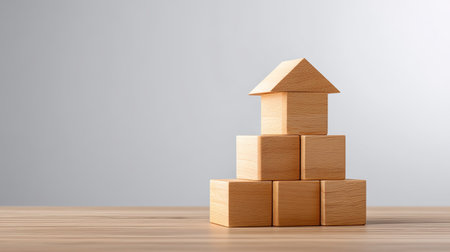 A creative arrangement of wooden blocks forming a house shape, exemplifying simplicity and craftsmanship. Ideal for educational and creative themes.の素材