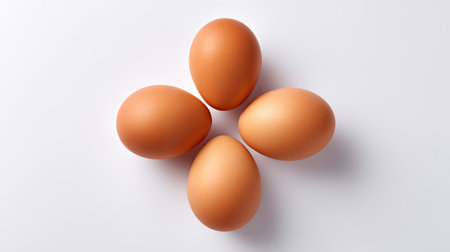 A visually appealing arrangement of fresh brown eggs on a clean white background, perfect for showcasing culinary creativity or promoting healthy meal options.の素材