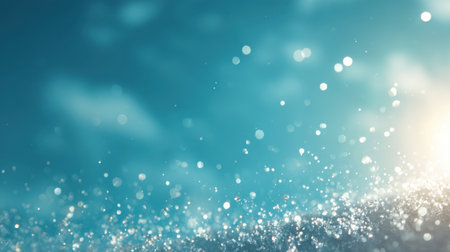 A soothing blue abstract background featuring sparkling water droplets and a gentle bokeh effect. Ideal for creating calm and relaxing visuals in design projects.の素材