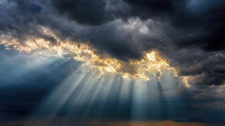 This stunning image captures the interplay of dark clouds and radiant sunlight streaming through, creating a breathtaking natural scene of beauty and tranquility.の素材
