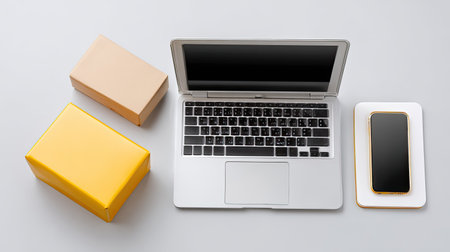 A sleek workspace featuring a laptop and smartphone surrounded by delivery boxes, perfect for showcasing e-commerce and remote work themes in a minimalist setting.の素材