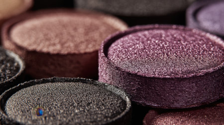 This image captures a close-up view of colorful eye shadow powders featuring rich textures and vibrant shades, ideal for makeup artists and beauty enthusiasts.の素材