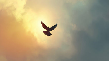 A stunning silhouette of a bird soaring through a vibrant sky at sunrise. The harmonious blend of warm light and dramatic clouds showcases the essence of freedom and beauty in nature.の素材
