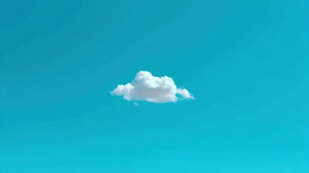 A single fluffy white cloud floats gracefully in a bright blue sky, creating a serene and peaceful atmosphere ideal for nature themes and tranquil backgrounds.の素材