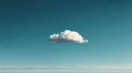 A beautiful isolated cloud floats gracefully in a clear blue sky, creating a serene and tranquil atmosphere. Perfect for minimalist nature aesthetics.の素材