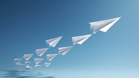 A stunning visual of paper airplanes flying upwards in a serene blue sky. This image symbolizes creativity, freedom, and the pursuit of dreams, perfect for inspirational themes.の素材