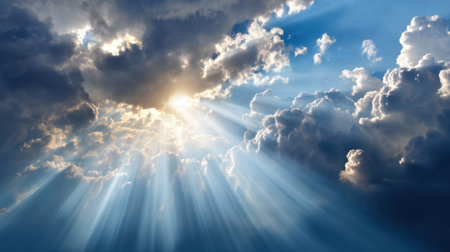 This stunning image captures the beauty of a dramatic sky filled with fluffy clouds, where bright sunlight breaks through, casting radiant beams of light, creating a serene atmosphere.の素材