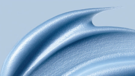 This close-up image showcases a silky light blue creamy texture against a soft background. Perfect for beauty and skincare product applications or advertisements.の素材