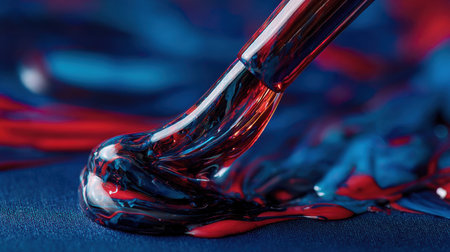 Close-up view of vibrant paint swirling and blending on a canvas, highlighting the glossy texture and fluid motion, perfect for artistic inspiration and creative projects.の素材