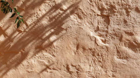 A beautifully textured beige wall illuminated by natural light, showcasing shadows that add depth and intrigue. Perfect for architectural and design projects.の素材