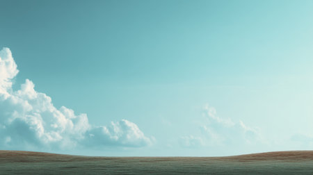 A captivating view of a clear blue sky stretching over a lush green meadow, featuring soft white clouds that evoke a sense of peace and tranquility in nature.の素材