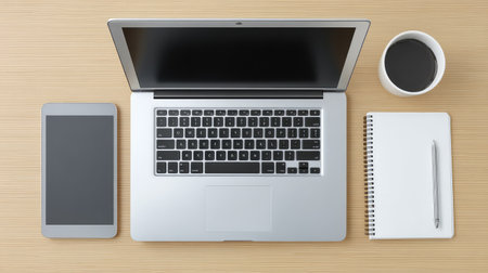A sleek and modern workspace featuring a laptop, tablet, coffee cup, notepad, and pen arranged neatly on a light wooden surface, promoting productivity and inspiration.の素材