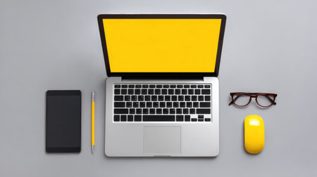 A sleek modern workspace showcasing a laptop, smartphone, glasses, pen, and mouse with yellow accents, perfect for digital productivity and minimalist design inspiration.の素材
