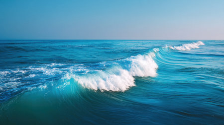 Experience the peaceful beauty of ocean waves glistening under sunlight, perfectly reflecting the clear blue sky and embodying the essence of nature's tranquility.の素材