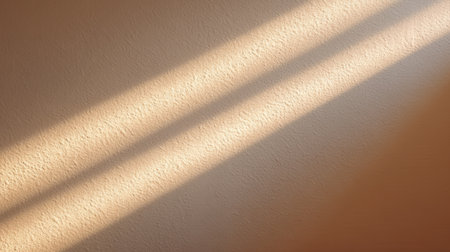 Capturing the beauty of soft sunlight casting gentle shadows on a textured wall, this image evokes a sense of warmth and tranquility, perfect for design inspiration.の素材