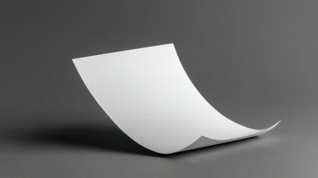 A beautiful smooth white paper sheet elegantly curved against a subtle grey background, offering ample space for creative designs and presentations. Ideal for various projects.の素材