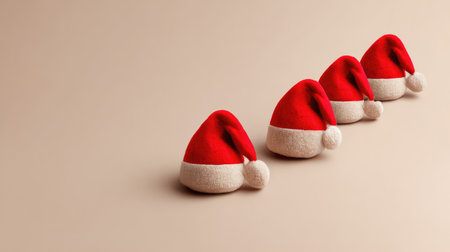 A vibrant collection of Santa hats arranged on a soft beige background, capturing the spirit of Christmas and adding a touch of festive cheer to any holiday-themed project.の素材