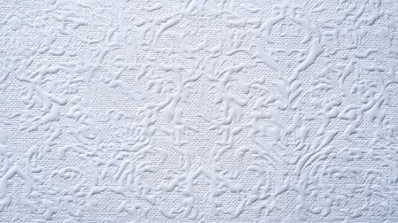 This image features a white textured background with intricate patterns, perfect for creative projects, interior design, and artistic endeavors.の素材