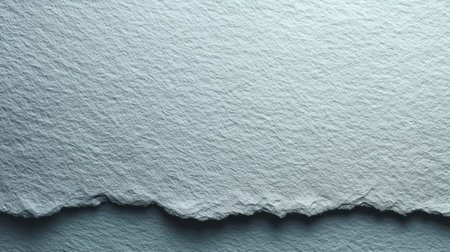 This image features a textured light blue paper with a torn edge, perfect for creative designs, printing projects, or artistic backgrounds in various applications.の素材