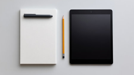 A clean and minimal workspace featuring a notepad, pencil, stylus, and tablet, ideal for highlighting creativity and productivity in any professional or academic setting.の素材