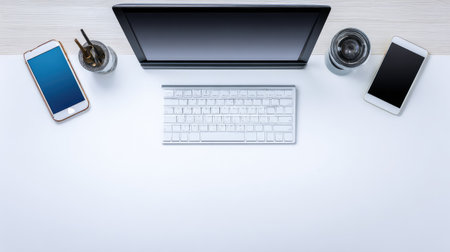 Experience a minimalistic workspace featuring a modern laptop, multiple smartphones, and stylish accessories, ideal for enhancing productivity and focus in a clean setting.の素材