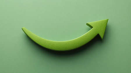A vibrant green arrow pointing upward against a textured background, symbolizing growth, progress, and success in various themes of business and personal development.の素材