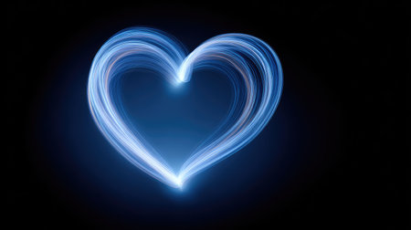A stunning abstract representation of a glowing heart shape formed by light trails, set against a dark backdrop, perfect for themes of love and emotion.の素材