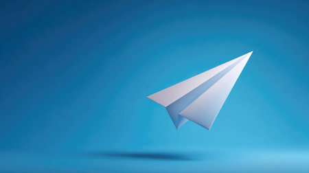 This image features a sleek paper airplane against a vibrant blue backdrop, symbolizing creativity and freedom, perfect for visual storytelling and design projects.の素材