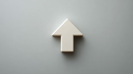 A modern design featuring a white arrow symbol on a soft gray background, ideal for themes of direction, progress, and minimalistic aesthetics in digital contexts.の素材